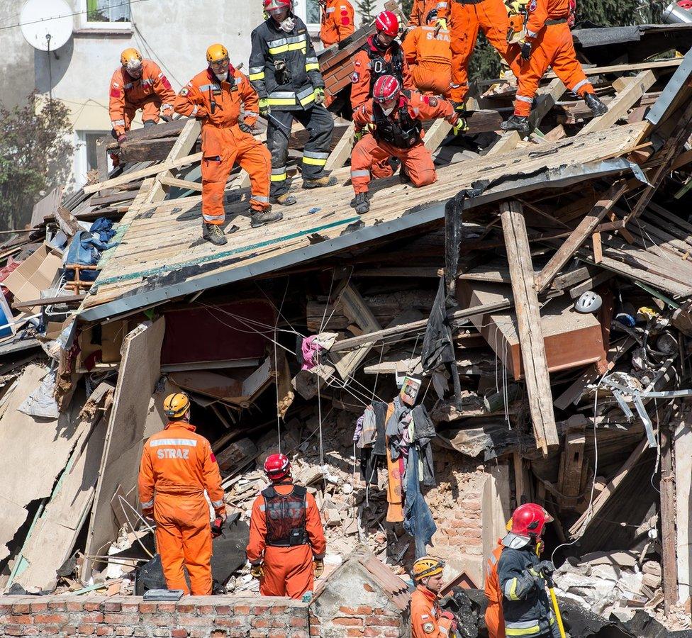 Polish rescue workers at the scene of the building collapse