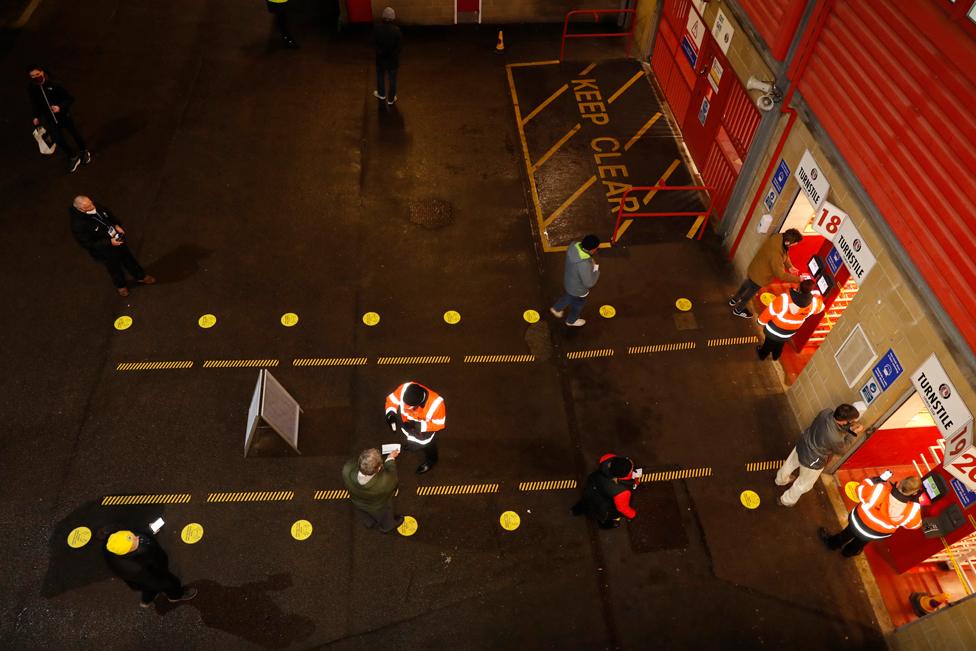 Aerial view of fans being checked by stewards outside the stadium in Charlton, London