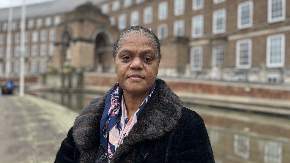 Patricia Davis-Thomas looks at the camera in a black coat in front of Bristol's civic offices