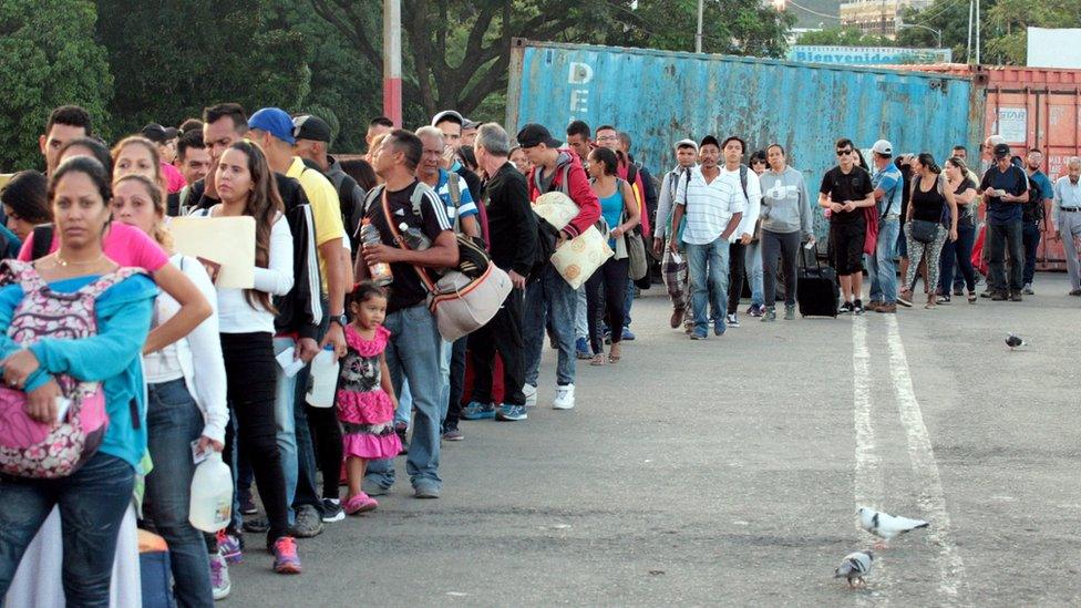 Venezuelan citizens cross from their country to Colombia, through the Simon Bolivar International Bridge, in Cucuta, Colombia