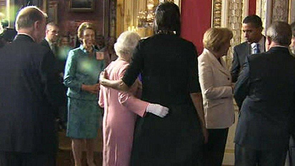 The Queen and Michelle Obama place their arms around each other at Buckingham Palace reception in 2009