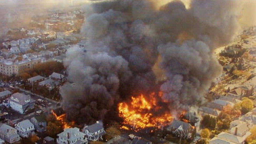 The wreckage of American Airlines flight 587 burns in the Rockaway neighbourhood of the Queens section of New York City (12 November 2001)