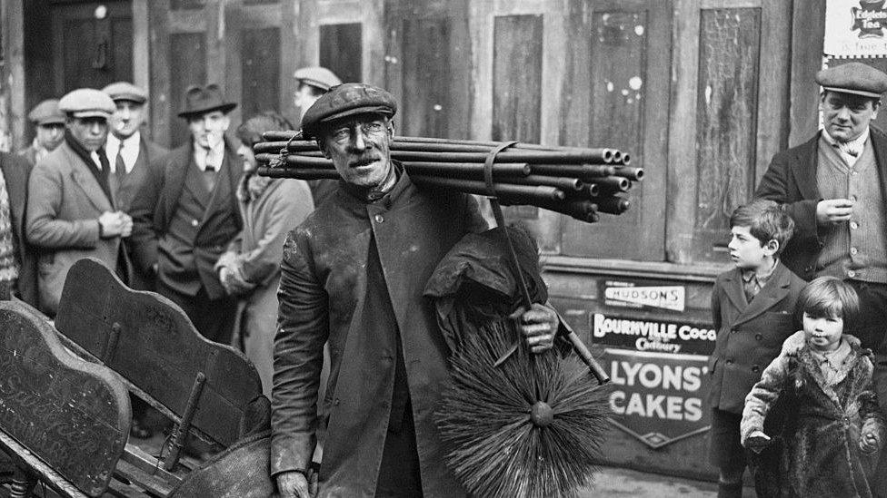 A chimney sweep in Bethnal Green in east London going to his morning's work, 1931