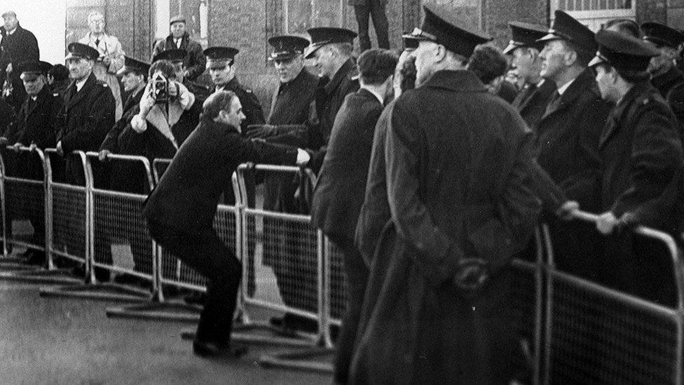 The scene in Derry in November 1968 at a civil rights demonstrations, where protesters are seen confronting RUC officers at safety barriers