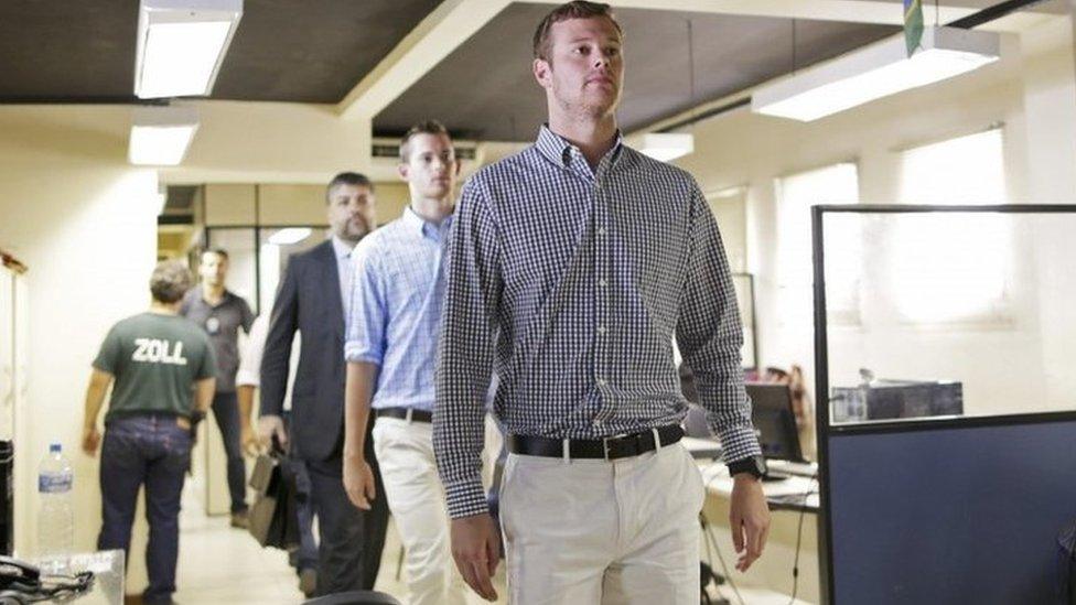 US swimmers Jack Conger and Gunnar Bentz are escorted into a police station the morning after they were stopped from boarding a flight to the United States, in Rio de Janeiro, August 18, 2016