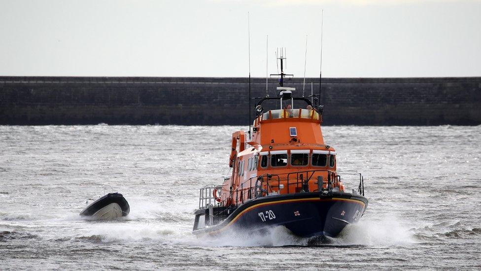 The inflatable boat being brought back to shore