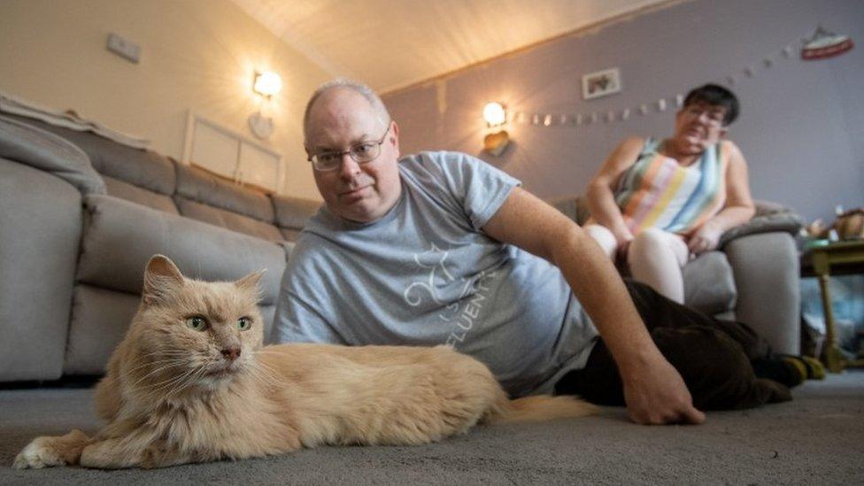 Keith, 53, and Su Bigland with his late mother"s beloved pet cat, Biscuit, known as Bikkit