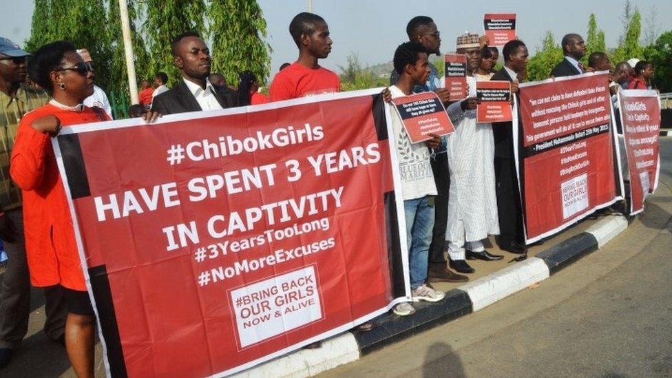 Protesters hold placards during a demonstration marking the third anniversary of the abduction of the Chibok girls in Abuja on April 14, 2017