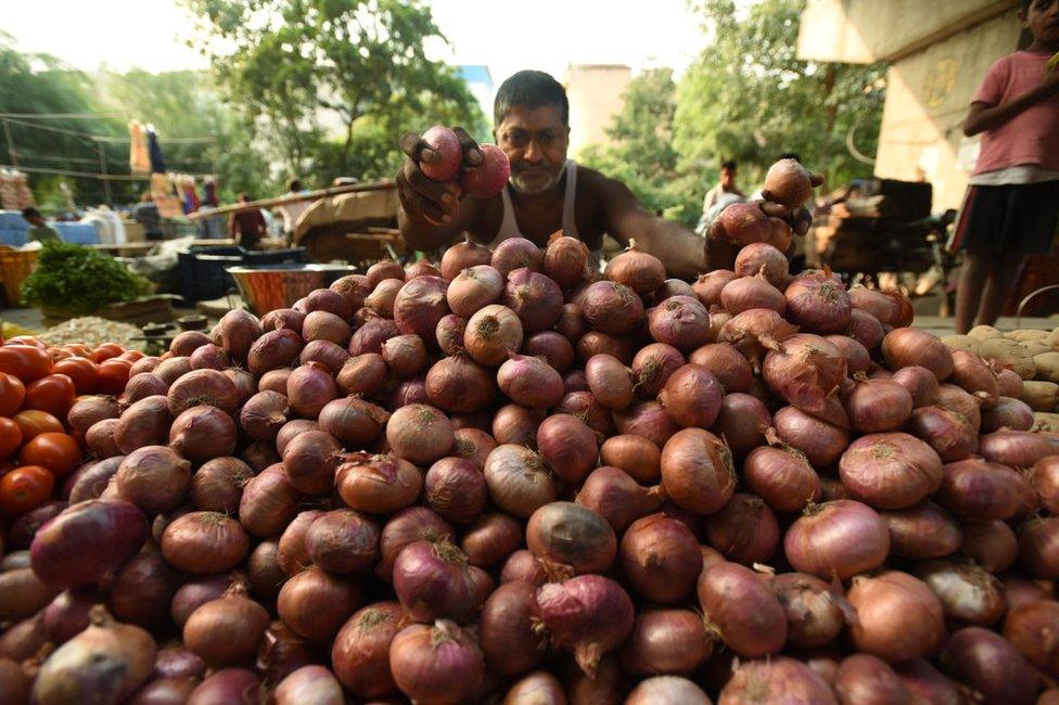 Vegetable vendors sell onions by the road, at Sector 25 on September 24, 2019 in Noida, India.