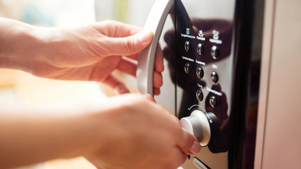 hand on microwave