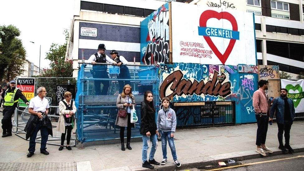 Crowds beside Grenfell sign