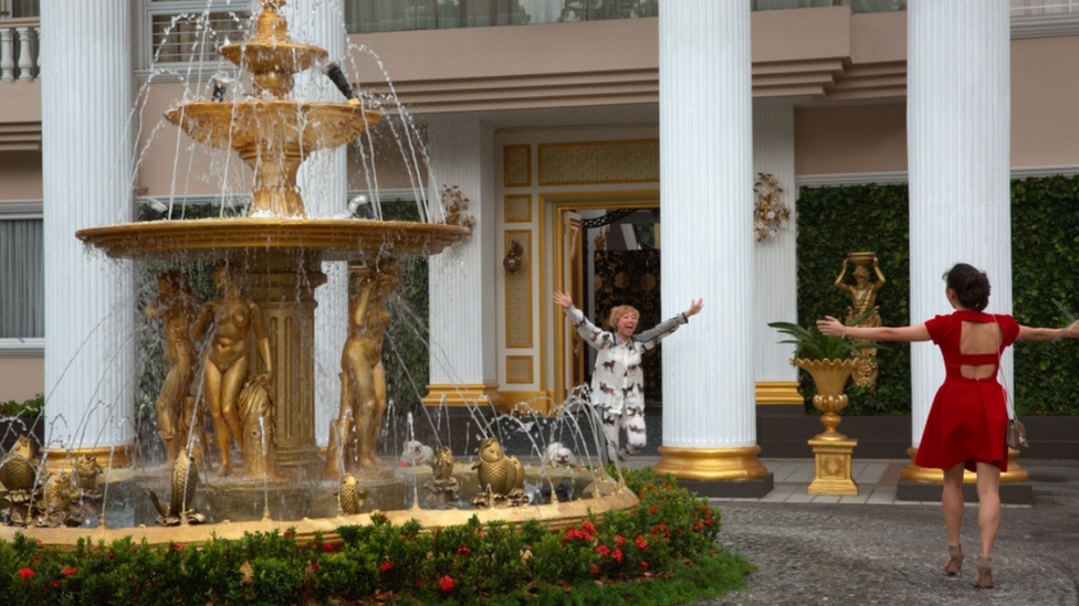 Movie still from Crazy Rich Asians showing Awkwafina and Constance Wu running towards each other