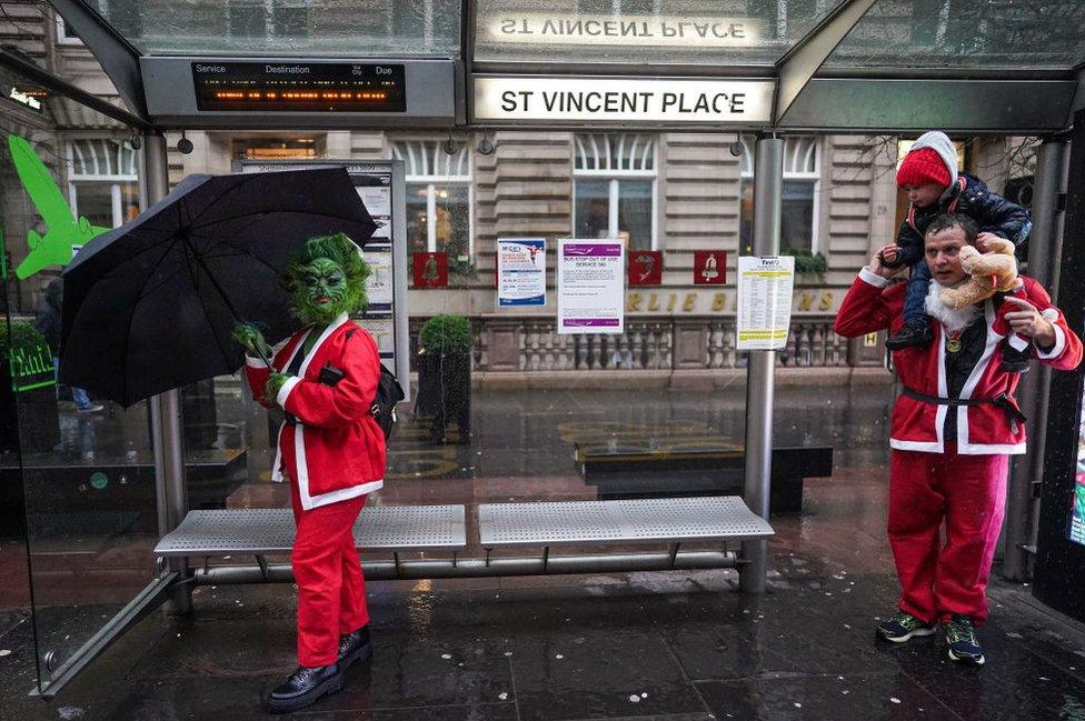 Santas at the bus stop