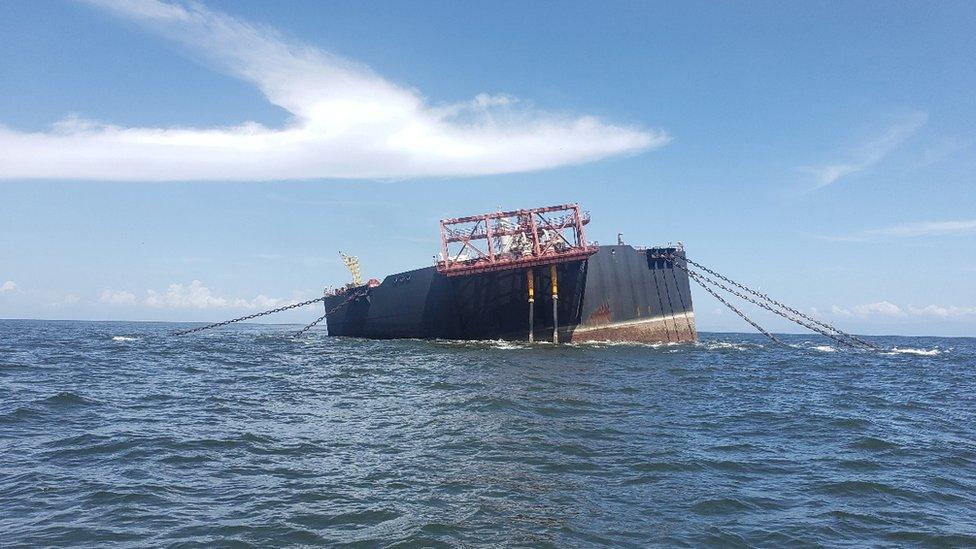 oil tanker at an angle in the ocean.