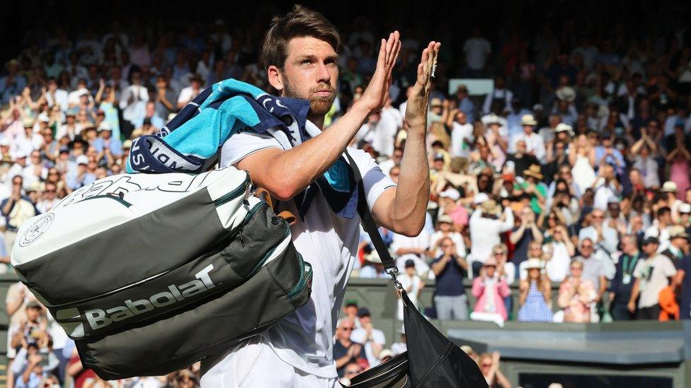 Cameron Norrie applauds the Centre Court crowd after losing the men's semi-final to Novak Djokovic