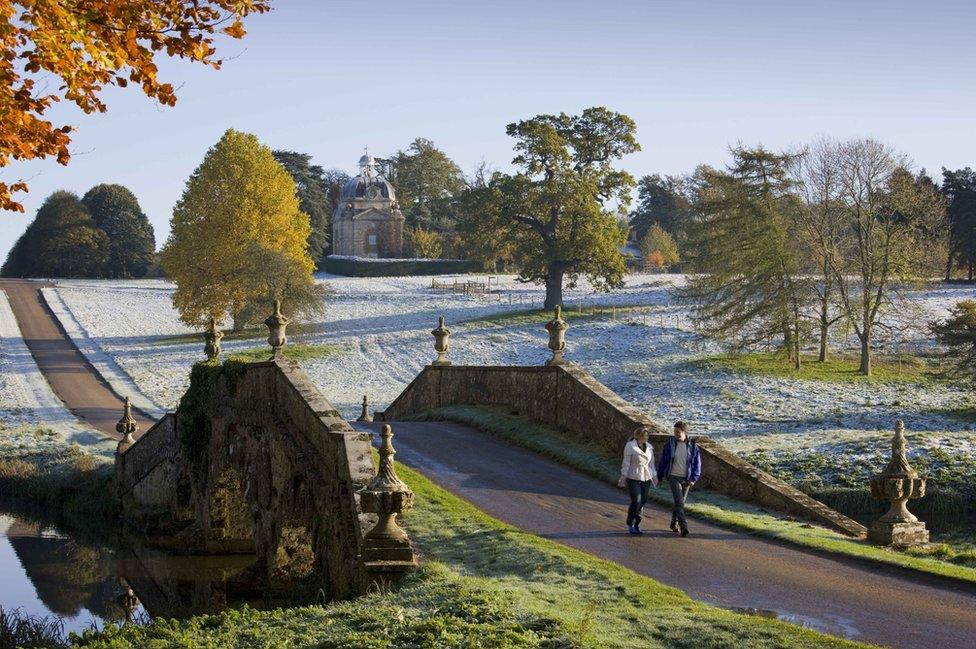 A couple walking through the wintry gardens of Stowe