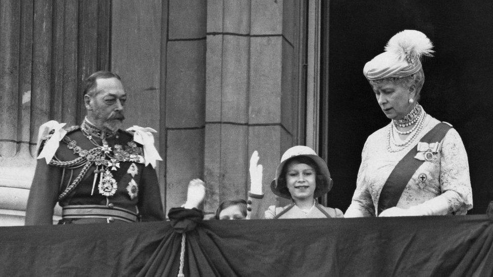 The future Queen Elizabeth II waving from the balcony of Buckingham Palace in London, with her younger sister Margaret and her grandparents King George V and Queen Mary, on the occasion of their Silver Jubilee, 6th May 1935