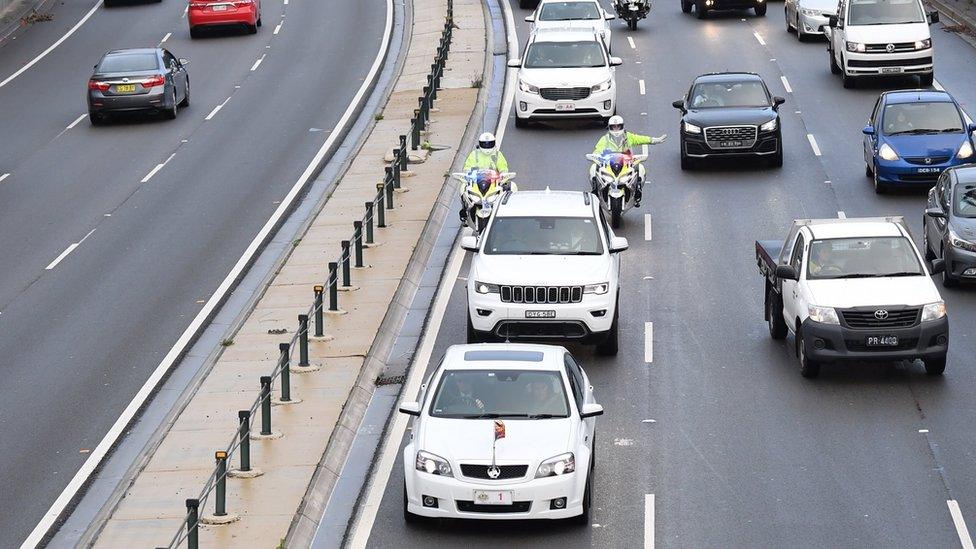 Police guard the royals' motorcade in Sydney