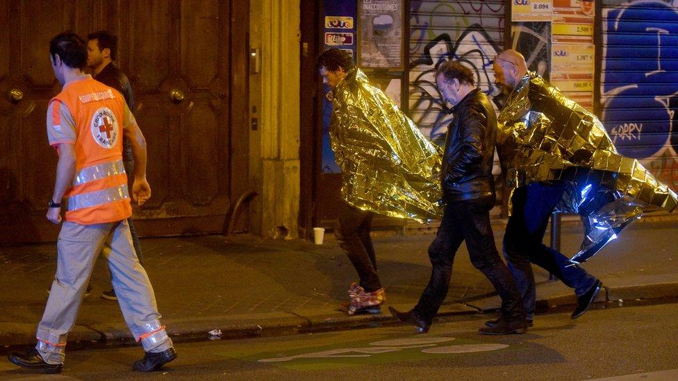 Survivors from the Bataclan leave the area