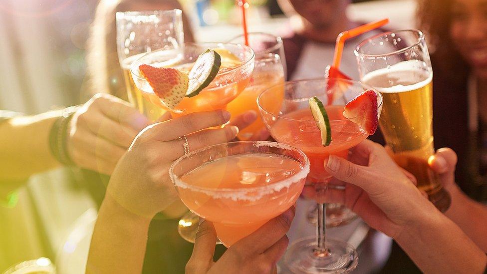 People toasting with cocktails