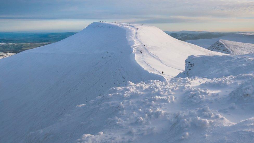 Walkers on a snowy Pen y Fan in the Brecon Beacons