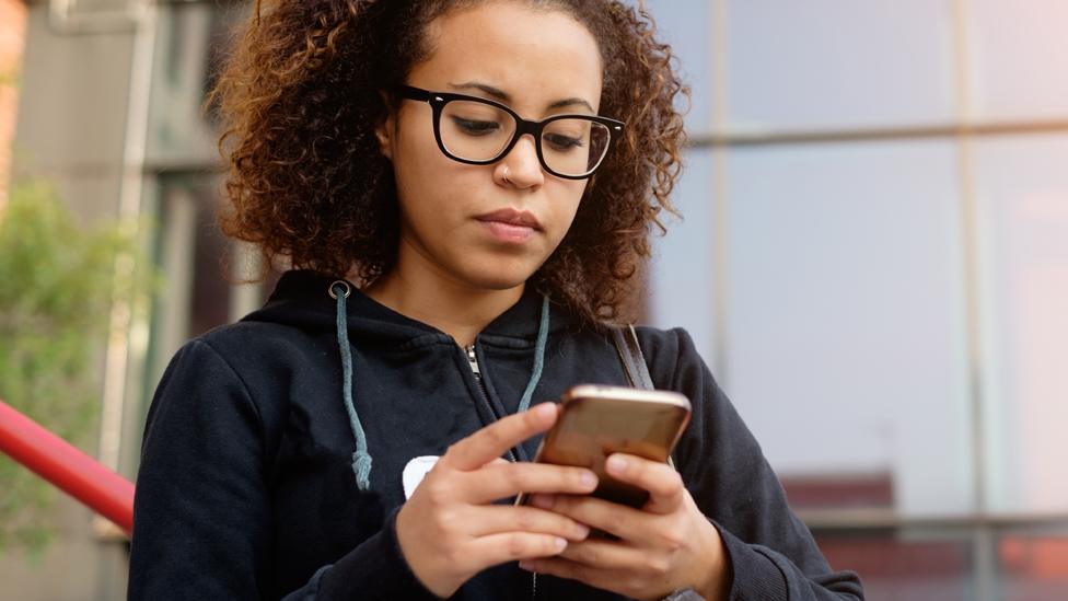 Young woman holding a mobile phone