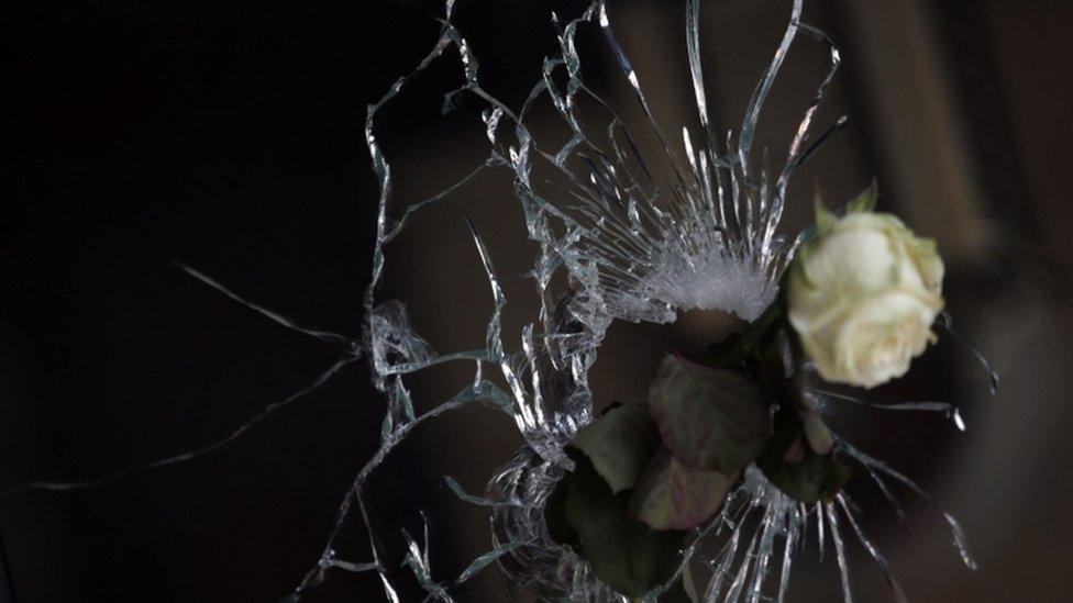 A rose in a bullet hole at a Paris restaurant