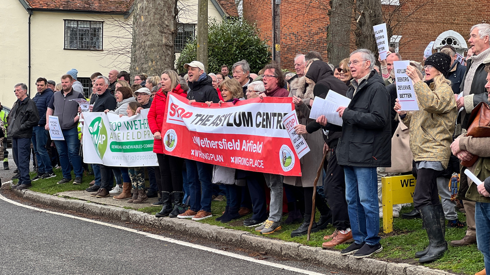 Protesters in Wethersfield, Essex holding large banners