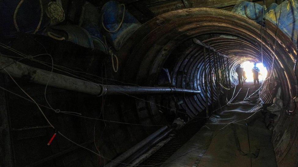 Israeli soldiers operate near the opening to what Israel's military says is an iron-girded tunnel close to Erez crossing in the northern Gaza Strip, December 15, 2023.