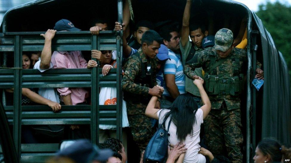 Soldiers guard a vehicle that is used to transport people in San Salvador on July 29, 2015, during the third day of a transport strike in El Salvador over the lack of security in the violence-plagued country.