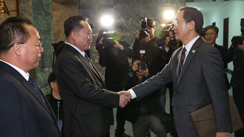 South Korean Unification Minister Cho Myoung-gyon (R) shakes hands with North Korea"s Committee for Peaceful Reunification chairman Ri Son-gwon (2-L) at the Tongilgak building on the northern side of the border of the truce village of Panmunjom, North Korea on 29 March 2018.