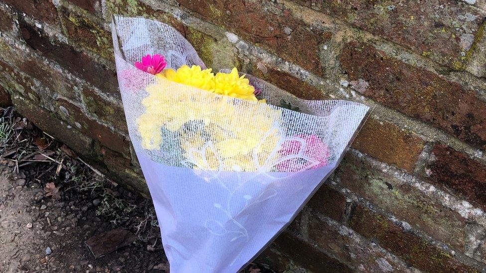 A floral tribute left outside the property boundary in Halstead Road