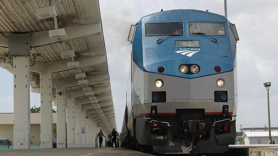 An Amtrak train stands at a platform in Miami.