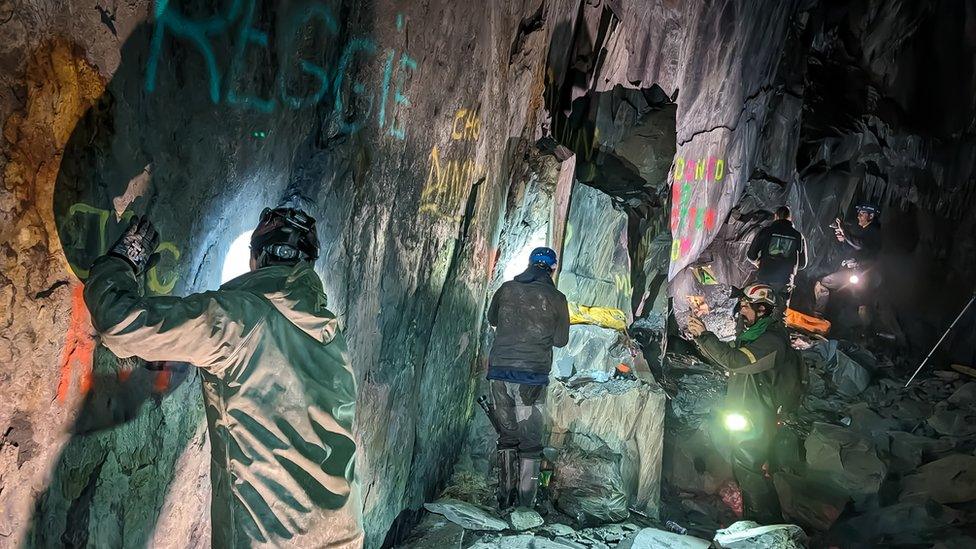 the volunteers at the bottom of a shaft doing graffiti clean-up