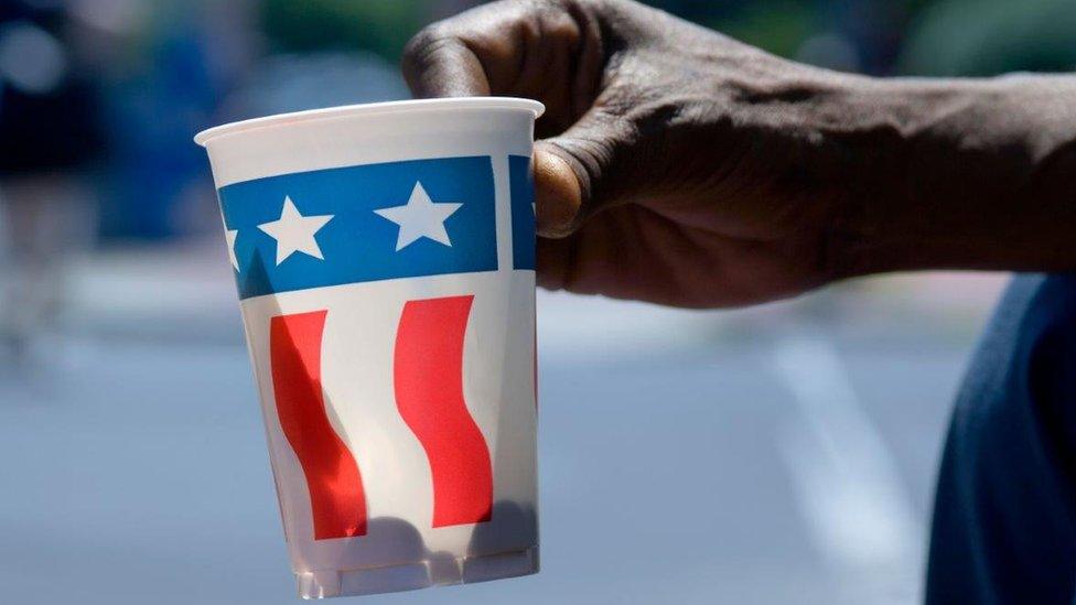 A begging cup themed with the stars and stripes of the American flag