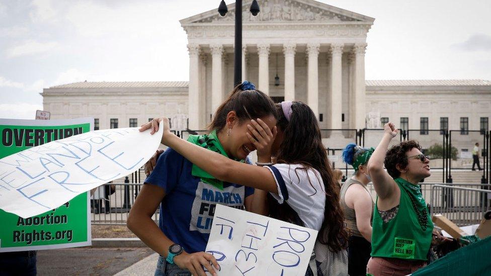 Abortion rights activists Carrie McDonald (L) and Soraya Bata react to the Dobbs v Jackson Women’s Health Organization ruling which overturns the landmark abortion Roe v. Wade case in front of the U.S. Supreme Court on June 24, 2022 in Washington, DC