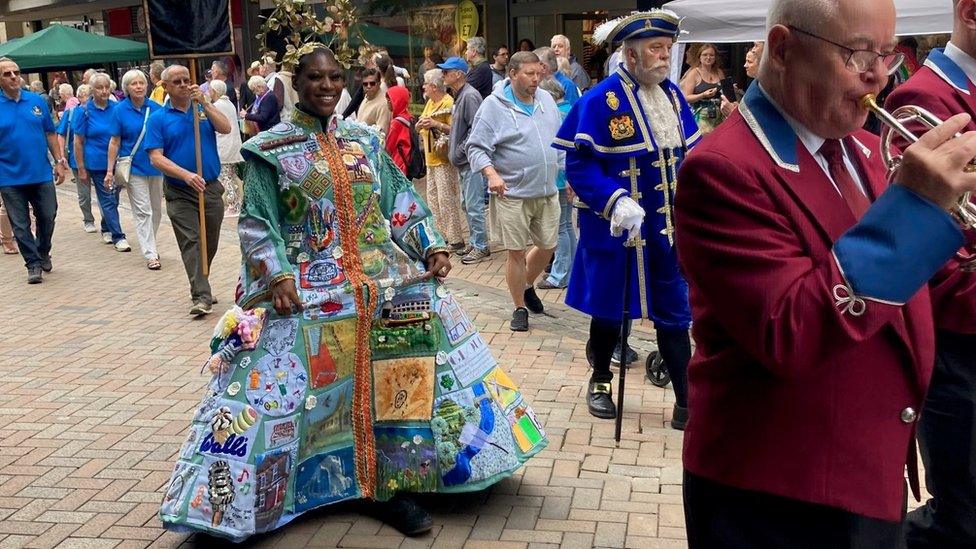 A woman in a brightly coloured costume