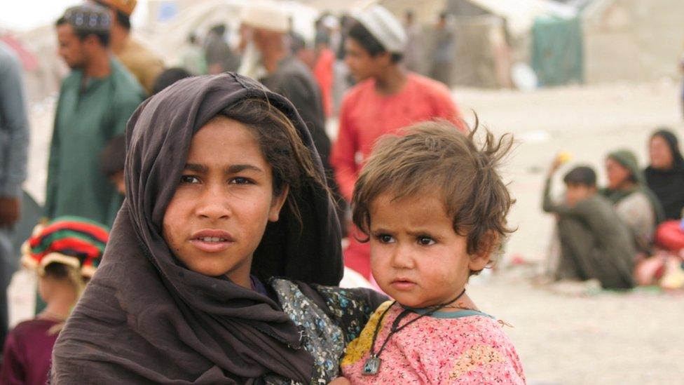 Siblings in Afghanistan are seen at their makeshift tents