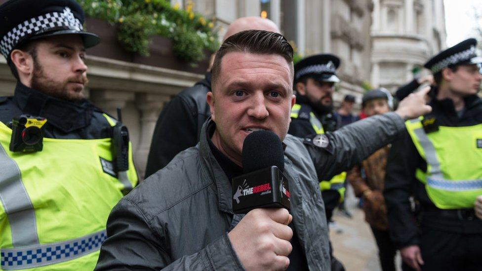 Tommy Robinson in front of police officers