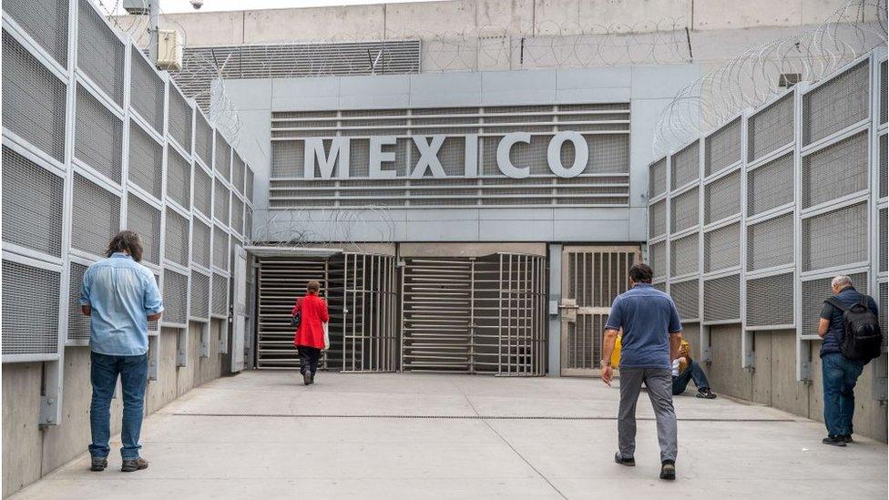 People walk towards Mexico from San Ysidro, California