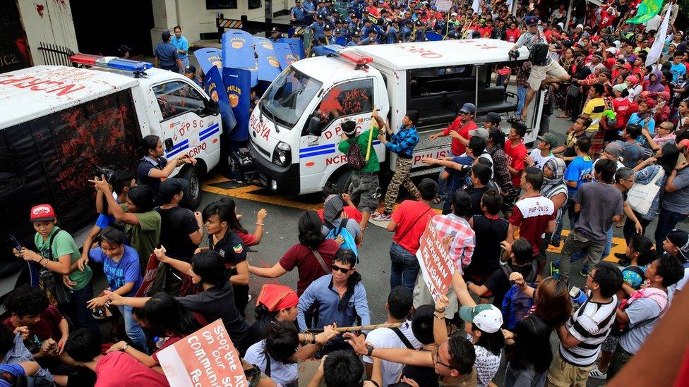 Protesters try to trash a police mobile patrol vehicle as they join various activist and Indigenous People"s (IP) groups in a protest against the continuing presence of U.S. troops in the Philippines in front of the U.S. Embassy in metro Manila, Philippines October 19, 2016