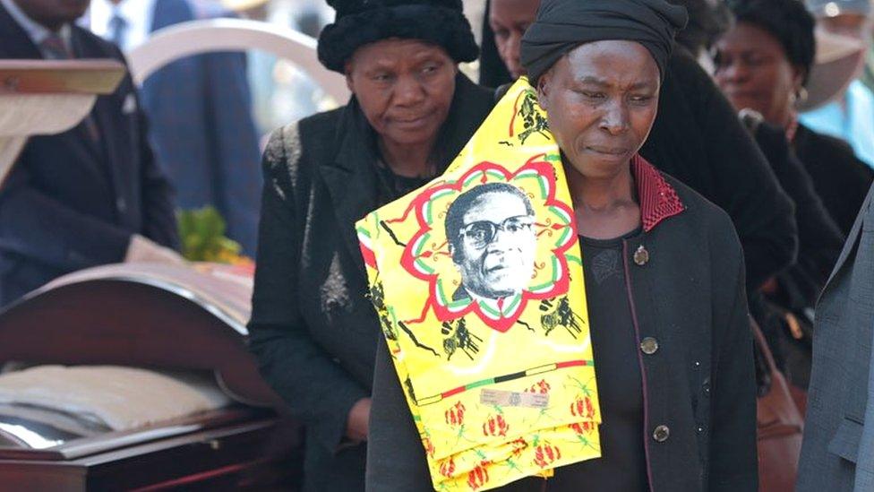 Woman looking sad after viewing coffin