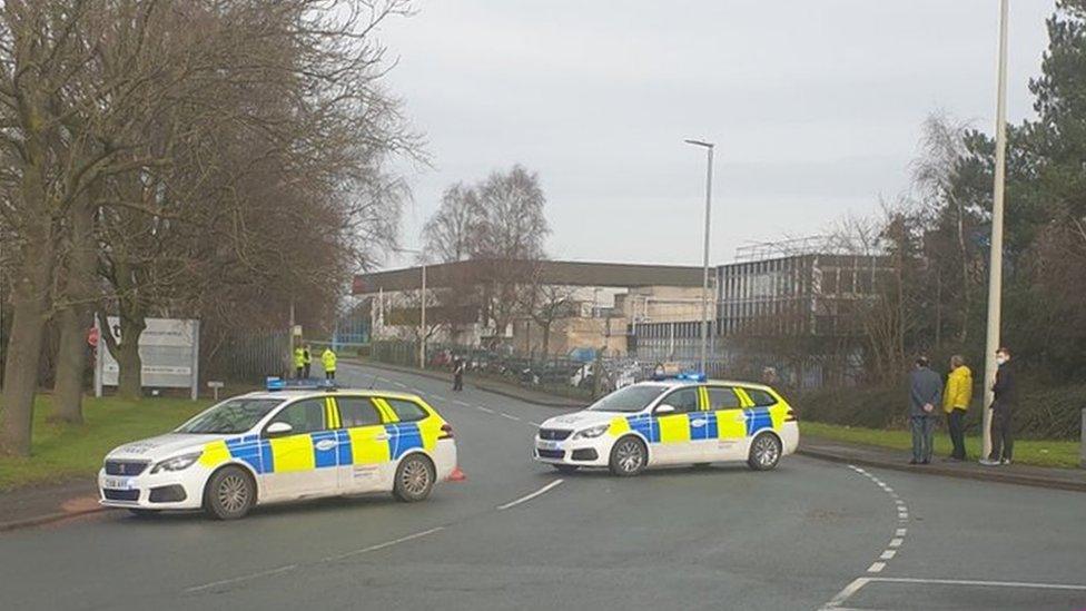 Police vehicles at the plant