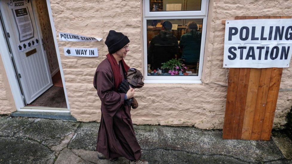 A Buddhist reverend leaves a station in Northumberland