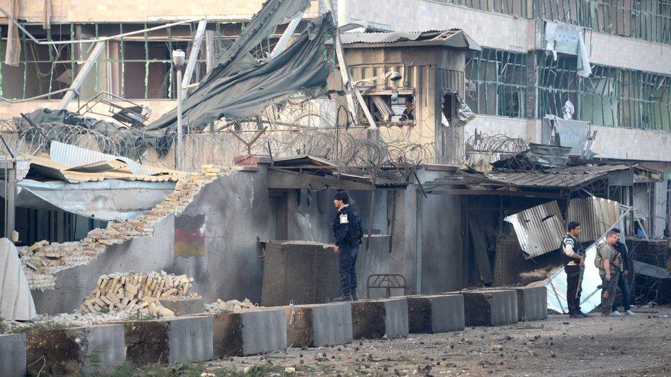 Afghan security personnel inspect the site of an attack targeting the German consulate in Mazar-i-Sharif on November 11, 2016.