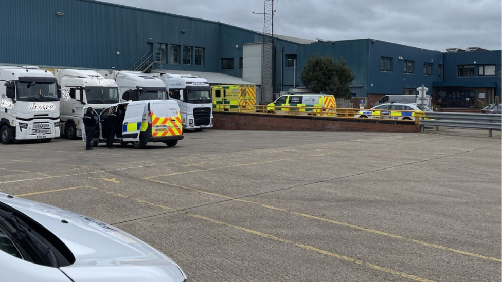 Police vans with lorries