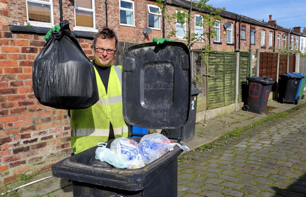 Hugh Fearnley-Whittingstall holding bin bags