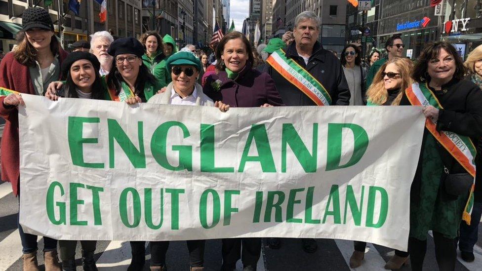 Mary Lou McDonald marching with banner