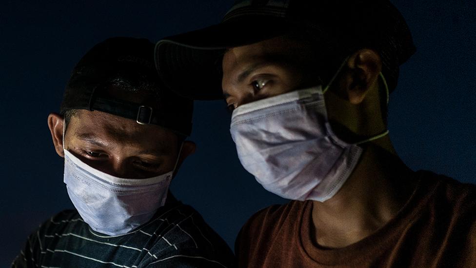 Two men wearing masks in Aceh