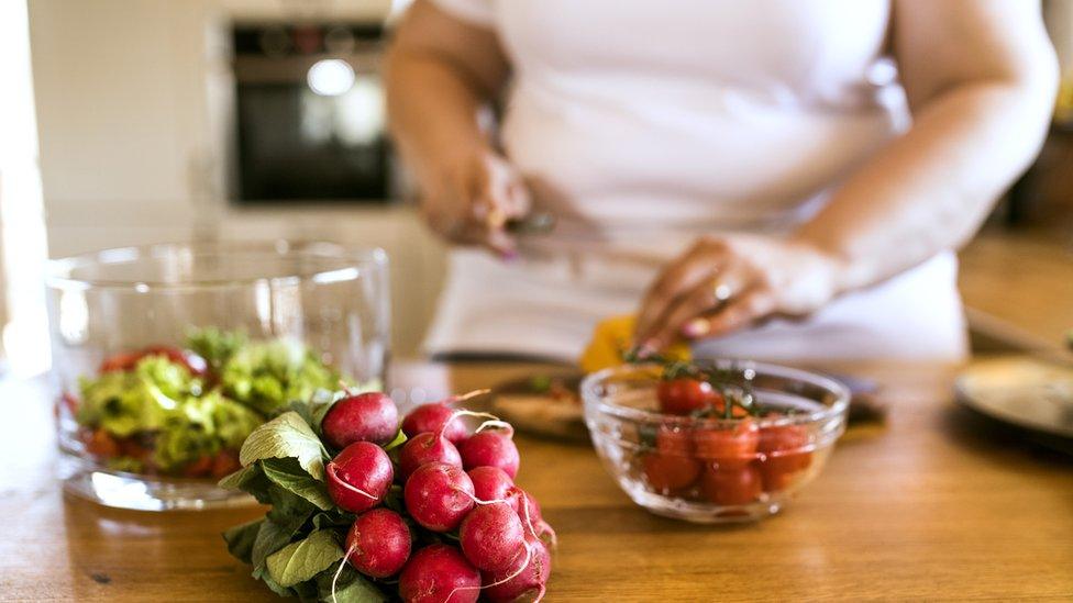 Overweight woman preparing healthy food